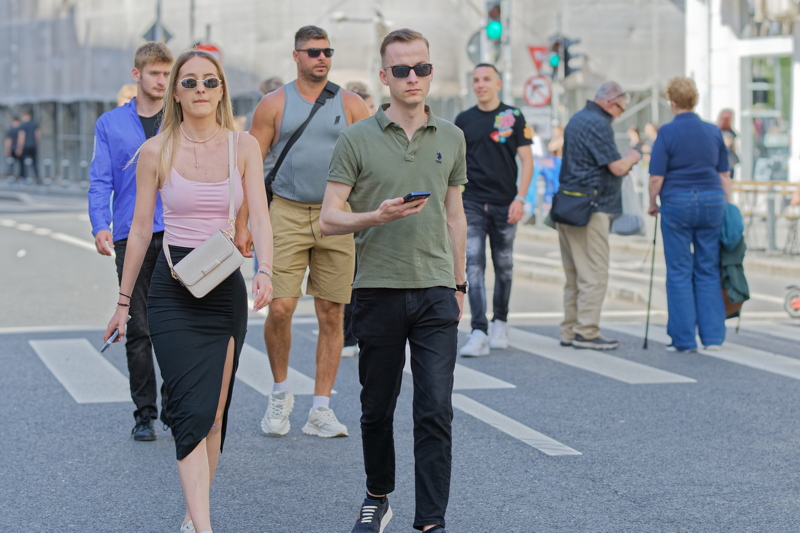 21 - Group of individuals in casual attire, including sunglasses, polo shirts, and tank tops